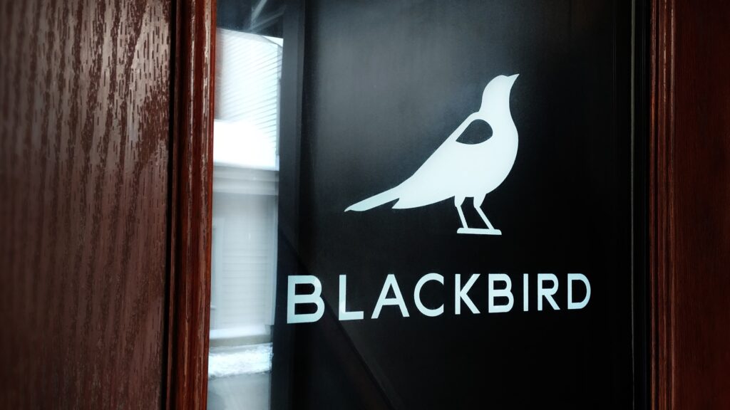 Blackbird logo decal in white on the office front door.