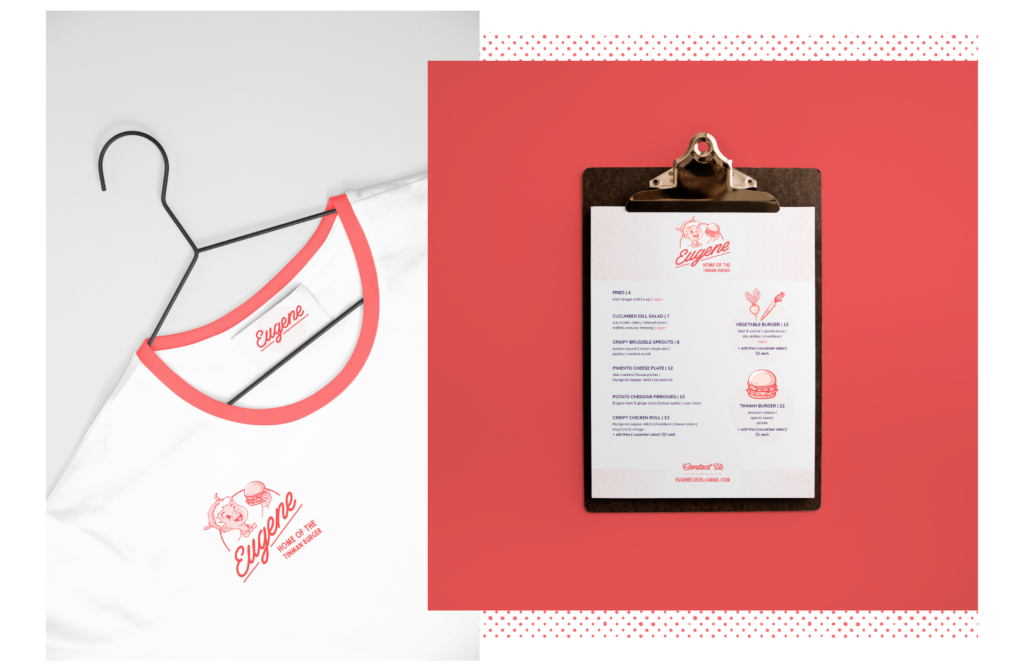 Eugene shirt mock-up on the left, red collar, white shirt, Eugene logo on the left side. Eugene menu mock-up on the right, Eugene, Home of the Tinman Burger" logo on the top, two columns listing out menu items. Burger and veggie illustrations. Contact information at the bottom. Mock-up is on a clipboard.