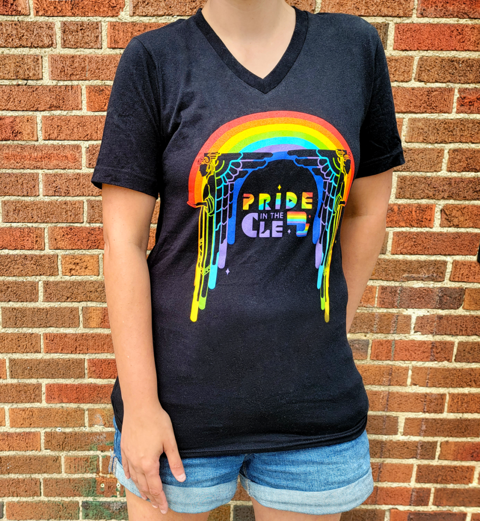 Person wearing a Pride in the CLE design on a black t-shirt standing against a brick wall